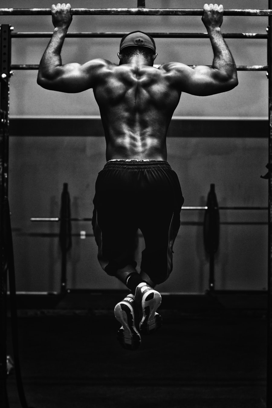 Athlete mid pull-up in black and white