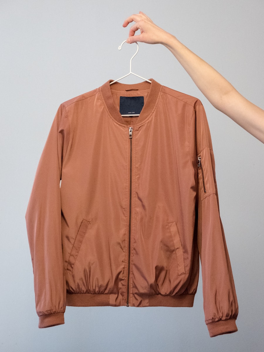 Aurelia Flight Jacket — amber nylon bomber on a hanger