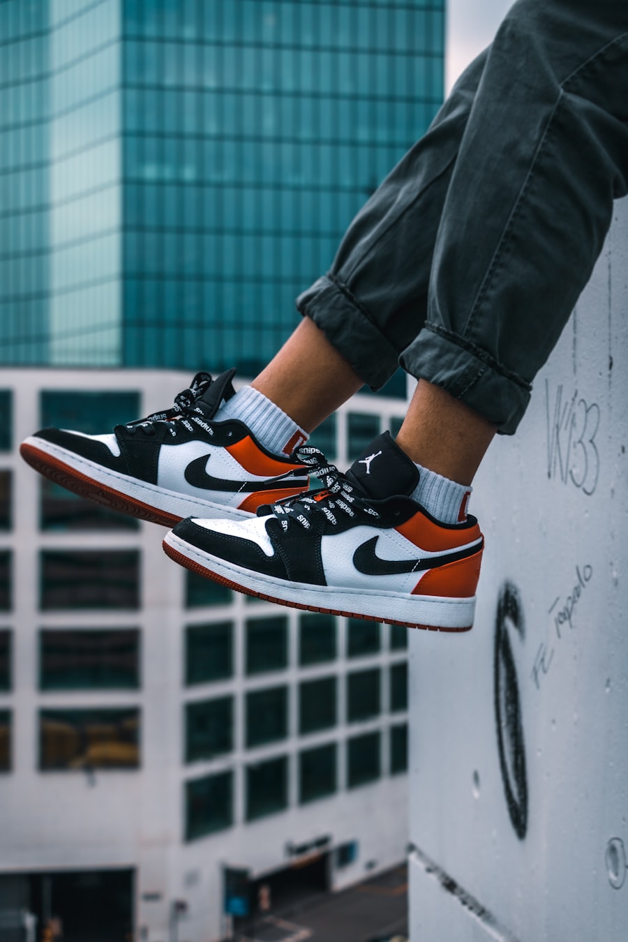Crown Court Low — court sneakers worn over a city ledge