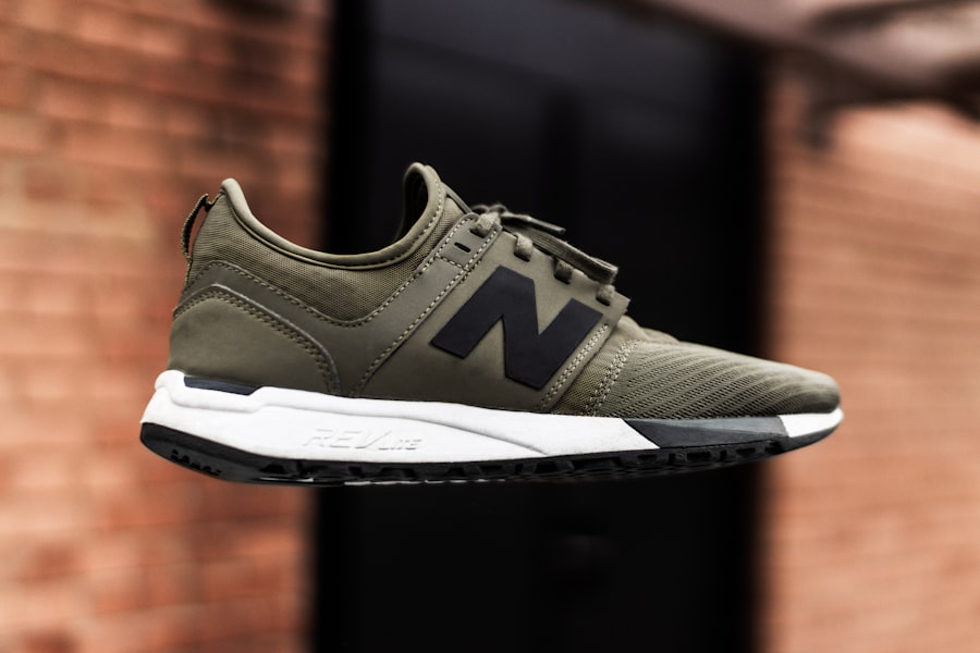 Midas Runner — olive knit running shoe floating against brick