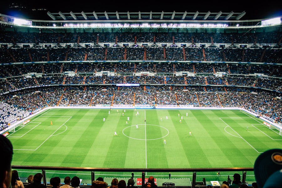 Football stadium under floodlights on match night